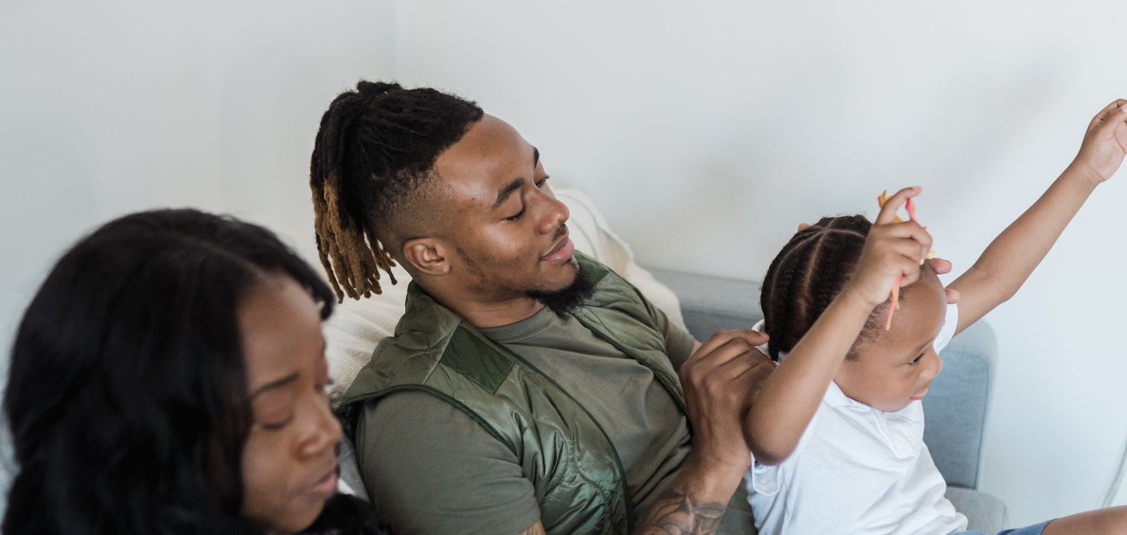 A family relaxing and laughing together on the couch at home